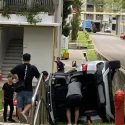 Car flips onto its side next to HDB block in Bedok, believed to have skidded