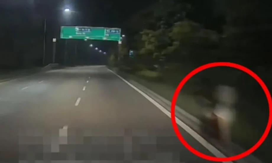 Mystery woman in white spotted pushing stroller along KJE at 2.30am