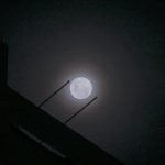 Wolf supermoon peers through cloudy night sky above Singapore