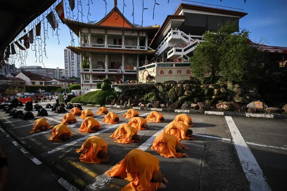 Every three steps, one bow: More than 7,000 devotees perform Buddhist ceremony to mark Vesak Day