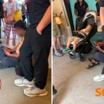 Singapore MRT commuter blocks train doors