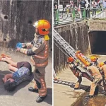 Woman falls into drain, rider shields her