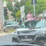 Kids seen standing through GetGo car’s sunroof