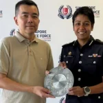 Man gets award from police for aiding in arrest of suspected thief on flight to Singapore
