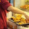 Ubi stall employee puts yong tau foo ingredients on tray