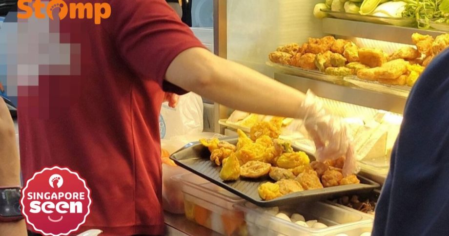 Ubi stall employee puts yong tau foo ingredients on tray