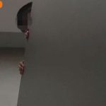 Boy peeks over toilet cubicle at Oasis Terraces