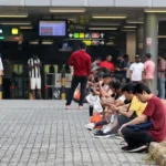 Smokers gather near Woodlands MRT station, leaving cigarette butts for others to deal with
